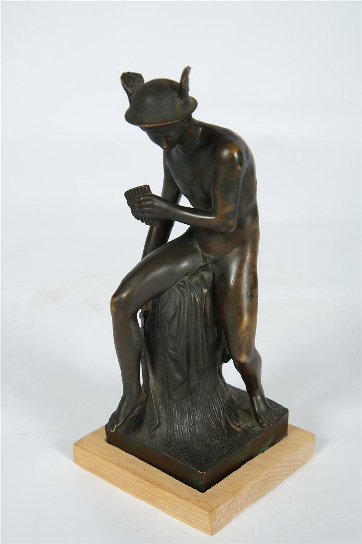 Bronze Hermes Sculpture: Bronze. Height: 11 1/2", Length: 4 3/4", Depth: 5". Bronze sculpture of the Greek god Hermes, featuring winged hat and pan pipes. Mounted on wood block base. Appears unmarked. Provenance: From the col