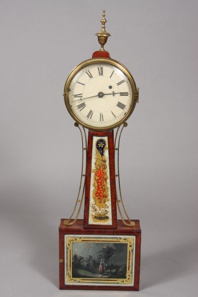 American Federal Mahogany Banjo Clock, 2nd Quarter: Brass urn finial over a round Roman numeral dial over rectangular reverse painted on glass throat panel decorated in gilt, cobalt and red with a scrolled and star motif, above a lower case decorated w