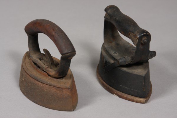 Two Victorian Cast Iron Irons, late 19th/ early 20: with turned wooden handles. Height: 5" Length: 6"