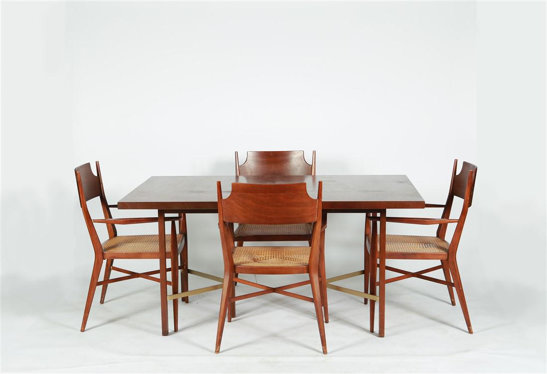 Style of Paul McCobb, Walnut Dining Set: Dining Set. Walnut, brass, and caning. Dining Chair: Height: 34", Length: 21 1/2", Depth: 18". Dining Table (Without Leaf Inserts): Height: 29 1/2", Length: 38", Depth: 60 1/4". Leaf Inserts: Length: