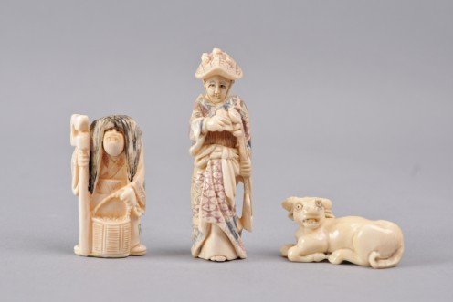 Three Carved Ivory Netsuke, Water buffalo, Geisha,: Three carved ivory netsuke, Japanese, 20th century. Including water buffalo, Geisha holding musical instrument and an actor with a rotating head displaying Two (2) faces. Each is decorated with painte