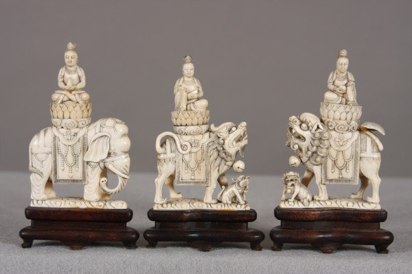 Set of Three Carved Ivory Buddhist Figures, Chines: Each seated on the back of an elephant, lion or chimera and intricately carved. Height: 5" Condition: Underside of one of lions tails has glue residue. Glue residue on front foot of elephant and at ba