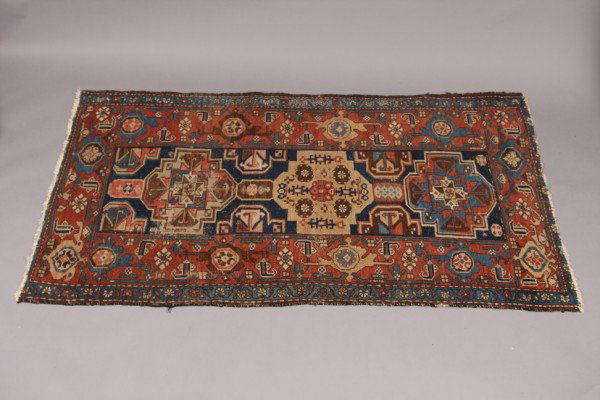 Caucasian Rug, Iran, Late 19th Century, 6' 3" x 3': Cobalt field with 3 blue, red and gold medallions within a blue, sand and brown geometric border. Dimensions: 6' 3" x 3' 7" Condition: The Nap Is Worn Overall. Two Sections Of Waer Down To The Base Th