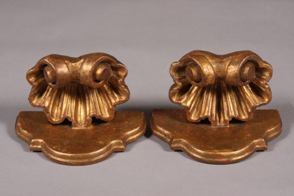 Pair Rococo Style Gilt & Carved Wood Brackets, Cont: Continental, 20th century. Shaped shelf supported by a shell. Height: 5 1/4" Condition: The gilt finish on both is distressed.
