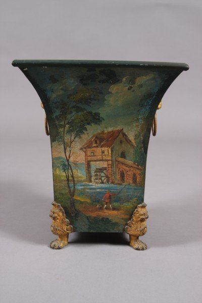 Tole Jardiniere, French, Late 19th Century, Figures: French, late 19th century. Square flaring body decorated with figures beside a mill in landscape. Raised on lion mask and paw feet. Height: 13 1/2" Condition: Paint is chipped and rubbed. finish on th