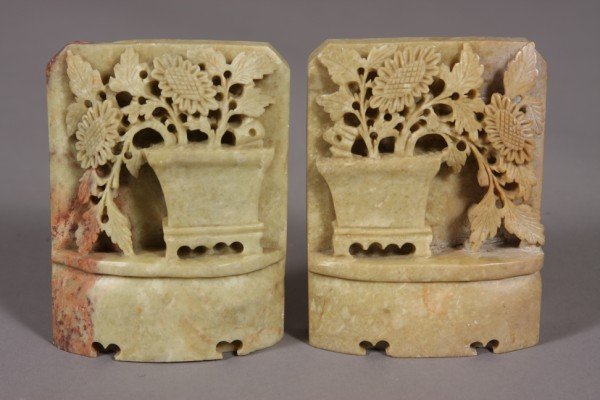 Pair Carved Soapstone Book Ends, Chinese, 20th Cen: Chinese, 20th century. Carved with a planter and flowering plant. Height: 5 1/4" Condition: Appears fine, One (1) with a creves on the top.
