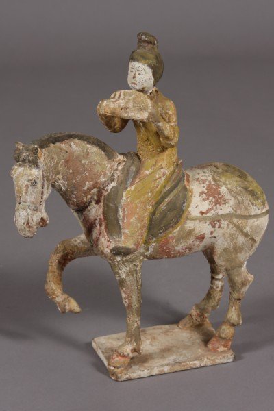 Pottery Equestrian Figure, Chinese, Probably Tang : Chinese, probably Tang Dynasty. A man with a musical pipe seated on horseback. Height: 13 1/2" Length: 10" Condition: The figures head is severed from the body. The horse is missing its tail. The hors