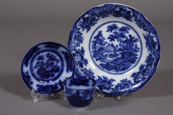 Group of Flow Blue Stoneware, English, Late 19th C: English, late 19th century. Including a bowl decorated with a pagoda reserve and floral border and a cup and saucer. Dimensions: Bowl Diameter: 10"