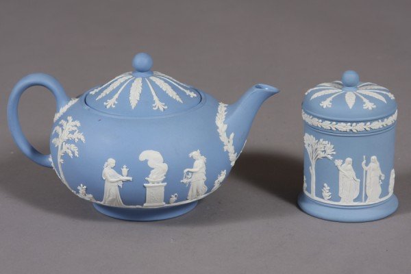Wedgwood Blue Jasperware Teapot, English, 20th C.,: English, 20th century. Globular form with neo-classical figural decoration. Together with a cylindrical covered box. Dimensions: Teapot Height: 5 1/2" Box Height: 4 1/2" Condition: The teapot with a r