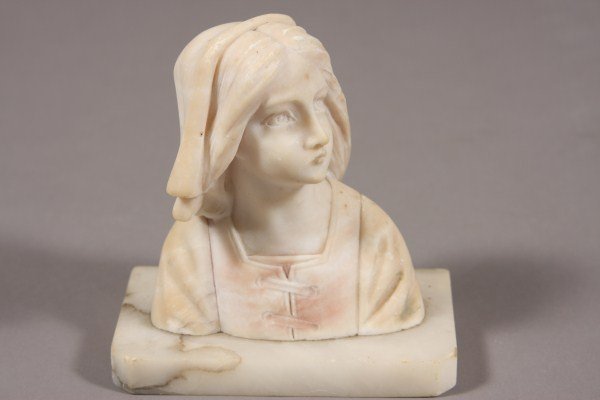 Sestine E. Paccarde, Italian, 20th C. Bust of a Mai: Italian, 20th century. Bust of a maiden wearing a cap. Carved marble. Signed and located on base. Height: 7" Condition: Few nicks from the rim of her hat.