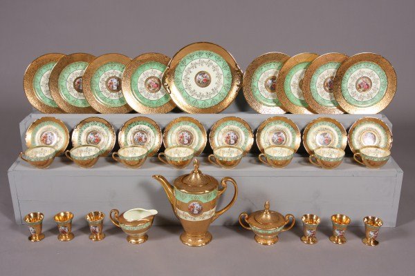 Le Mieux China Dessert Service, 20th C., Figural R: 20th century. Decorated with figural reserves against a 24K gilt ground and green borders. 34 pieces including 8 dessert plates, 8 tea cups and saucers, serving plate, coffee pot, creamer & sugar and