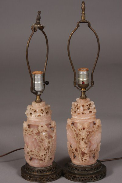 Pair Pink Carved Quartz Urns, Chinese, 20th C. Fit: Relief carved with flowering branches. Fitted as table lamps. Height: 20" Condition: With nicks overall to the edges of the flowers.