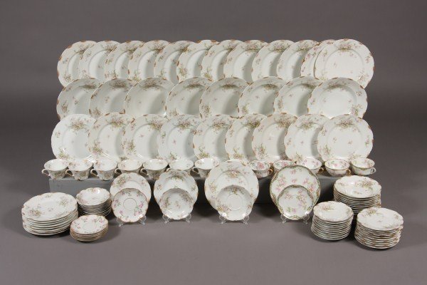 Assembled Limoges Porcelain Dinner Service, French: Early 20th century. With gilt border surrounding pink floral sprays. 105 pieces including: 11 dinner plates and 1 in a different pattern, 18 luncheon plates and 4 in a different pattern, 8 rim soups, 