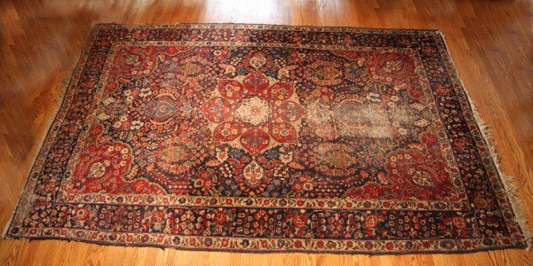 Sarouk Rug, Iranian, 20th C. Cobalt, Red, Rose & S: Cobalt, red, rose and sand floral border surrounding red central medallion and overall red, rose, blue and sand floral motif against cobalt ground. Dimensions: 9' 8" x 6' 5". Condition: One end is ver