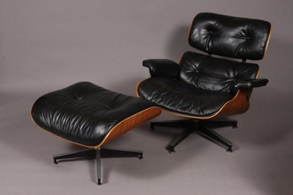 Rosewood & Black Leather Lounge Chair & Ottoman, D: Designed by Charles Eames for Herman Miller. #670/671. With rosewood frame and black leather seat. With original tag. Chair Dimensions: H 32"; W 34"; D 28". Condition: Leather upholstery is worn along