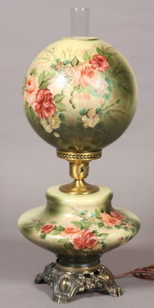 Victorian Blown Glass GWTW Oil Lamp, American, 20th: 20th century. Gone with the wind lamp painted with roses. H 24 1/2". Condition: Electrified. Finish on brass base is worn. Chip to shade rim.