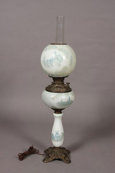 Victorian Blown Glass GWTW Oil Lamp, American or Co: American or Continental, late 19th/ early 20th century. Gone with the wind lamp transfer decorated with Dutch scenes. H 25". Condition: Electrified. The transfer scenes on the shade are rubbed. Finish