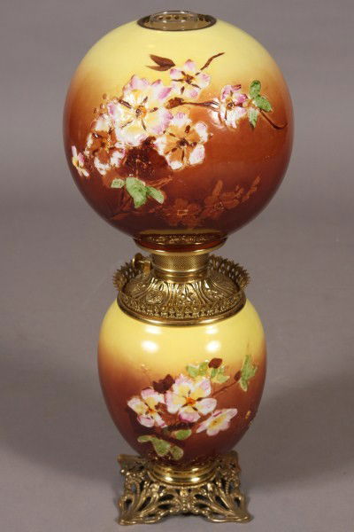 Victorian Blown Glass GWTW Oil Lamp, American, Late: Late 19th/ early 20th century. Gone with the wind lamp relief molded with dogwood blossoms. H 23 1/2". Condition: Appears fine.