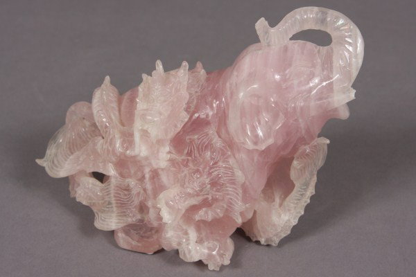 Carved Rose Quartz Elephant, Chinese, 20th C. Surr: Surrounded by a withering dragon. H 5"; W 6 1/2". Condition: The end of the trunk and the tusks are chipped.