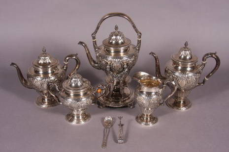 International Sterling Silver Tea and Coffee: International Sterling Silver Tea and Coffee Service. American, 20th Century. Decorated with a repousse center medallion surrounded by scrolling foliate motif. Including tea pot, coffee pot, kettle on