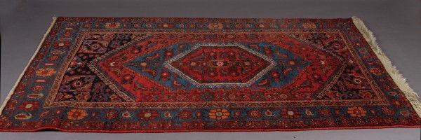 Hamadan Rug: Hamadan Rug. Northwest Iran, 20th Century. Center diamond with blue and red borders. 6' 8" x 4 3 1/2"Condition: One end repaired the other end is frayed.