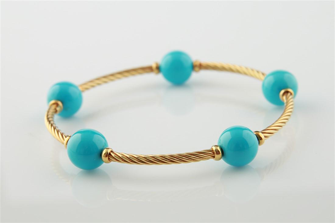 18k Yellow Gold Imitation Turq. Bangle Bracelet: 18k yellow gold imitation turquoise bangle bracelet. Piece is made up in a twisted design set with five imitation turquoise beads measuring 11mm. Bracelet is stamped 750 and weighs 19g.