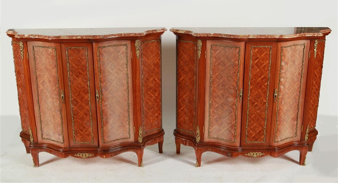 Pair of Serpentine-Front Marquetry Cabinets: Carved wood, marquetry, marble. Height: 40", Length: 46 1/4", Depth: 15 1/4". Pair of marquetry cabinets with two doors. Two shelves inside. Both doors lock with included key. Serpentine facade. Gold 