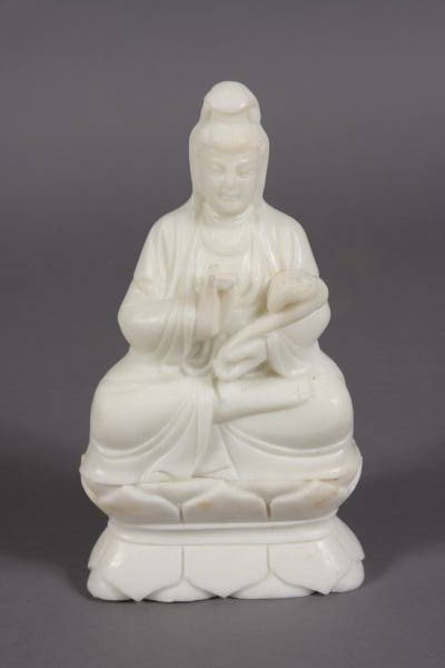 Seated Quan Yin, White Jade, Chinese, 20th C.: Seated Quan Yin. Chinese, 20th Century. White carved jade, H: 11 3/4", W: 6". Holding a scepter. Set on lotus base. Condition: Minor chip on the lower drape of one side.