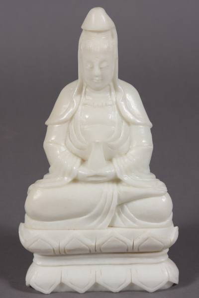 Seated Quan Yin, White Jade, Chinese, 20th C.: Seated Quan Yin. Chinese, 20th Century. White carved jade, H: 12", W: 6 1/2". Holding a vase. Set on lotus base. Condition: Natural cracks in the lotus base.