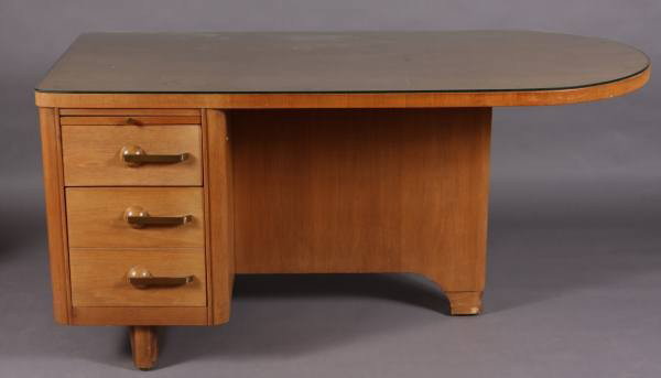 Mid-Century Walnut Desk, American, 20th Century: Mid-Century desk. American, 20th Century. In the manner of Donald Deskey. Walnut, H: 29", W: 60 1/2", D: 30". With rectangular top with one demi-lune end, having a slab support and a bank of drawers. 