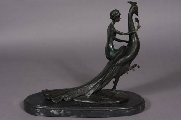 After Demetre H. Chiparus (1886-1947), Maiden...: After Demetre H. Chiparus (Romanian, 1886-1947). Maiden with a peacock. Bronze, H: 13", W: 11 1/2", Base L: 16". Signed and numbered "8/75" on oval marble base. Condition: The marble base is chipped.