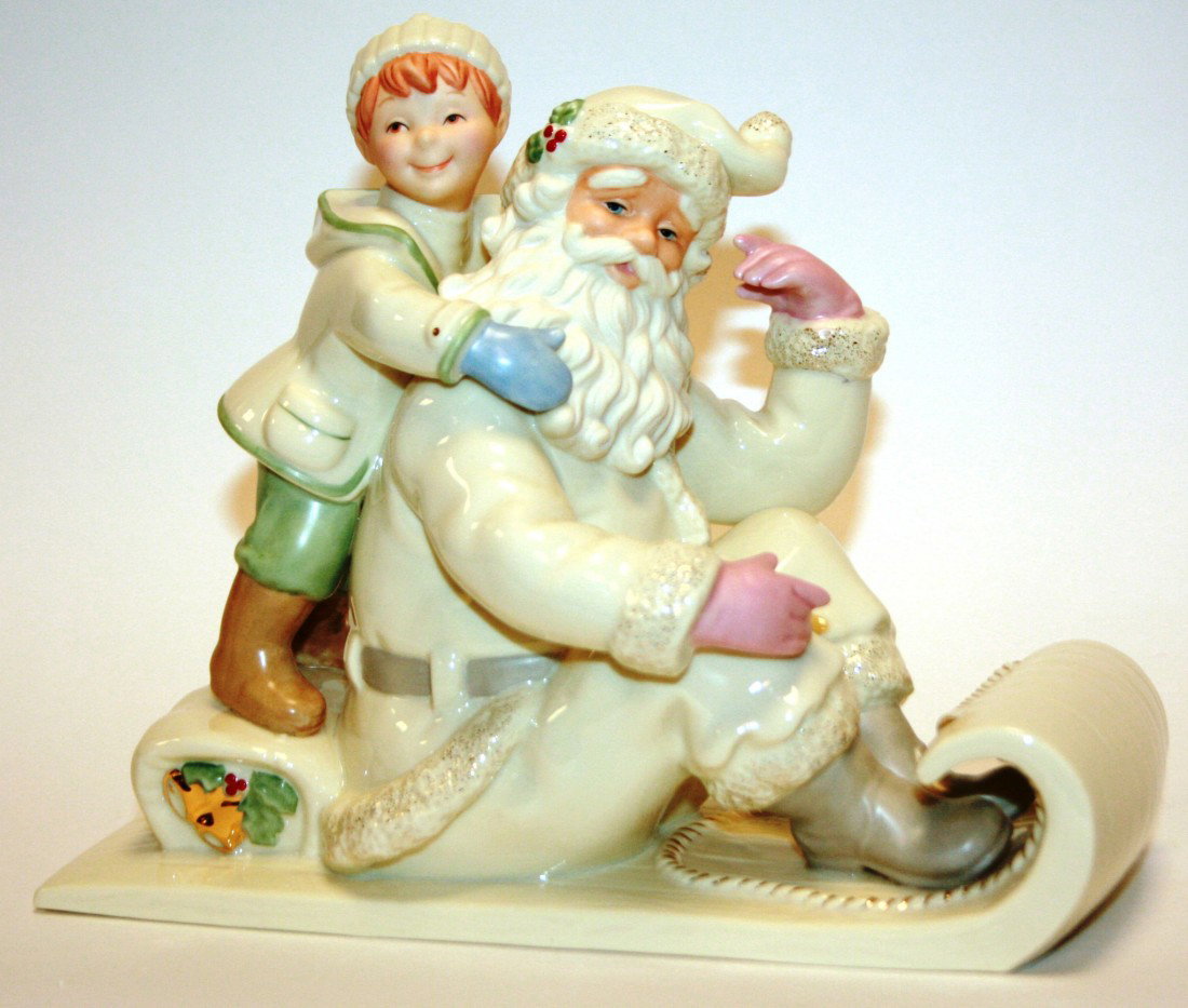 Lenox Classics "Holding on for the Holidays" Santa: Lenox Classics "Holding on for the Holidays" Santa Figurine on Sled, New in Box. #647B. Condition: Appears fine.