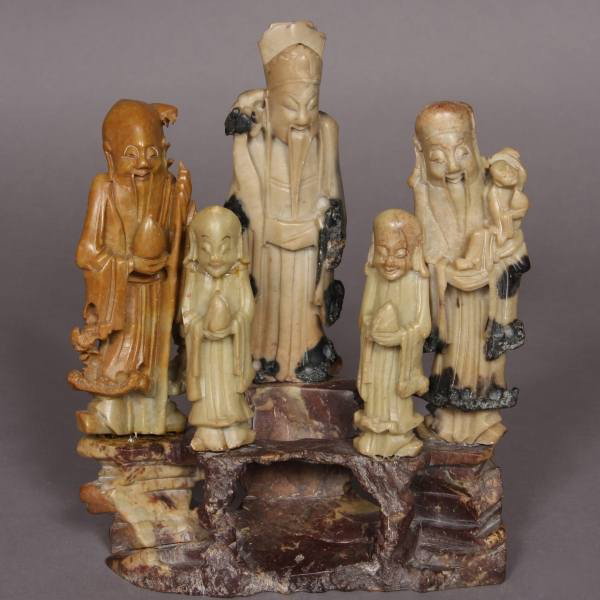 Carved Soapstone Figural Group, Chinese, 20th C.: Carved soapstone figural group. Chinese, 20th Century. With immortals on a rockery base. H: 9 1/4", W: 8". Condition: Figures have been attached to base with glue.