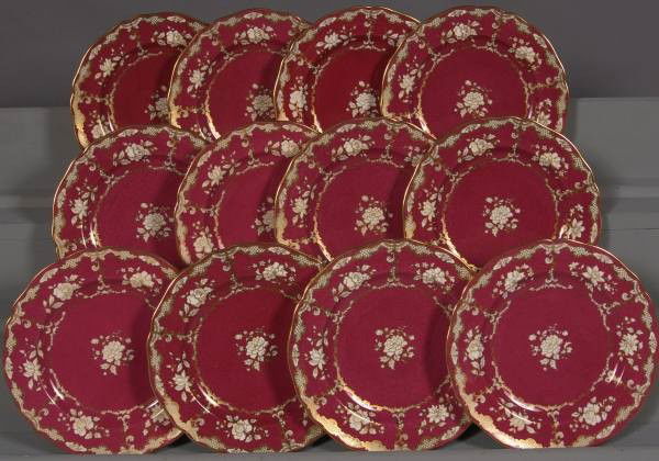 Set of Twelve Gilt & Claret Spode Luncheon Plates: Set of twelve Spode China luncheon plates. English, 20th Century. With gilt floral decoration against claret ground. Retailed by Tiffany and Company. D: 9". Condition: Minor wear to the gilt decoratio