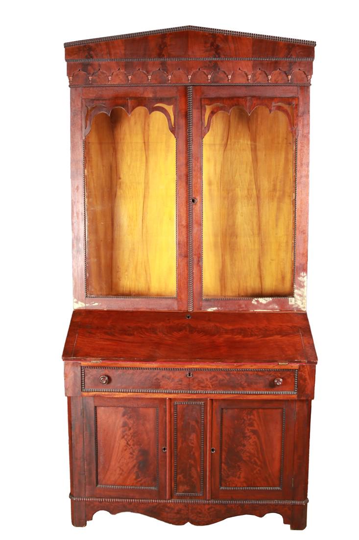 Empire Style Mahogany Two Piece Secretary: Mahogany, glass. c. 1840s. Hutch: Height: 50 3/4", Length: 44 1/2", Depth: 10 3/4". Desk: Height: 37 3/4", Length: 42 3/4", Depth: 19 1/2". Two-piece Empire style secretary. Two leaded glass doors to 