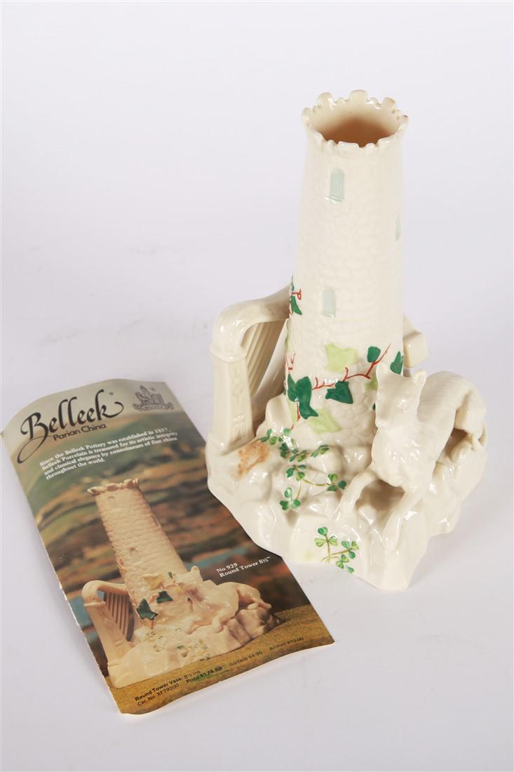 Belleek Irish Porcelain Castle Tower Vase 6th Mark: Belleek China (Irish). Parian china. Produced between 1965 - 1980. Height: 8 3/16", Length: 5 1/2", Depth: 5 1/2". Features hound, harp, and cross elements. The tower forms the opening of the vase. Be