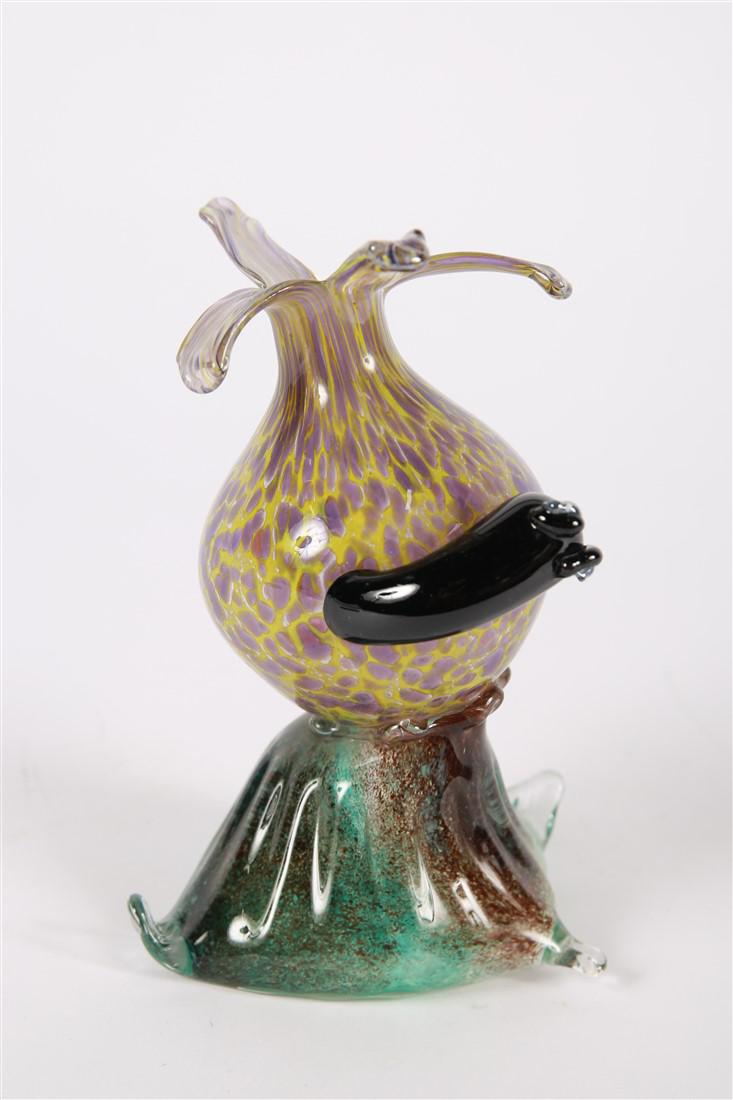 Art Glass Flower Sculpture with Slug: Glass, 2013. Height: 7 1/2", Length: 5", Depth: 4 1/4". Purple and yellow flower form with black slug and blue/green base. Signature to side of base reads something like, "Kimberly Tromp 2013".