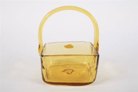 Blenko, Amber Glass Square Basket with Handle: Blenko Glass Company (American, est. 1893). Glass. Height: 8", Length: 6 3/4", Depth: 6". Square form amber glass basket with handle. Blenko logo sticker to the outside of basket.