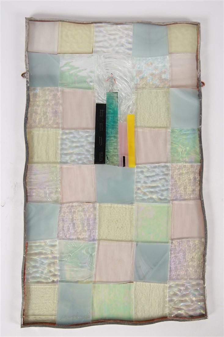 Janice Moorhead, Art Glass Cityscape Panel: Janice Moorhead (Canadian). Glass, plastic. 13 1/4" x 8 1/4". Iridescent, pastel colored, and textured checker panel of art glass, framing a small cityscape with a plastic figure above. Signed, "Moorh
