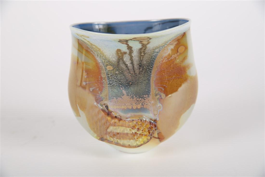 Robert Coleman, Iridescent Art Glass Vase: Robert Coleman (American, d. 2015). Glass, 2011. Patient Medicines Blown Glass. Height: 5", Length: 5", Depth: 4". Iridescent gold and cream exterior art glass vase with blue interior by Ohio based ar