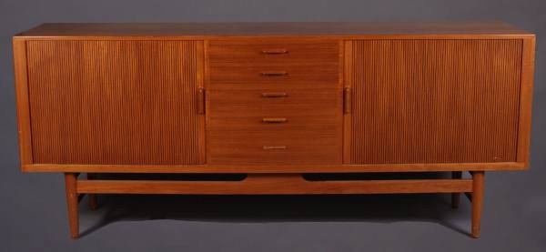 Mid-Century Teak Server, Danish, 20th Century: Mid-century teak server. Danish, 20th century. Rectangular case with five drawers and tambour compartments on turned tapering legs. Height 35 1/2", width 84", depth 19 1/2". Condition: A dent and mino