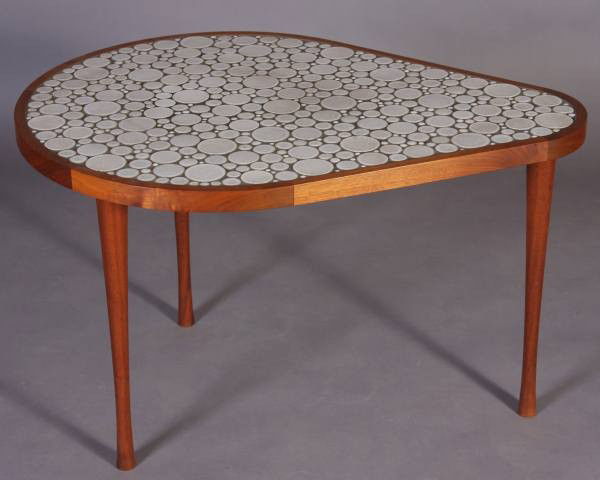 Mid-Century Side Table, Manner Of Gordon & Jane Martz: Mid-century walnut and tile inlaid side table. In the manner of Gordon and Jane Martz. With shaped top on tapered legs. Height 20", width 33 1/2", depth 24". Condition: Appears fine.