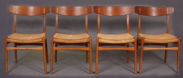 Four Hans Wegner Ash Side Chairs, Carl Hansen & Son: Set of four Hans Wegner ash side chairs. Made for Carl Hansen & Son. Denmark, 20th century. With woven grass seats. Condition: Wear to the feet. One seat is water stained. One chair the woven seat is