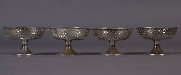 Four Sterling Silver Footed Sherbet Frames, 6 Ozt.: Four sterling silver footed sherbet frames. 6 troy ounces. Height 2 1/2". Condition: All are dented.