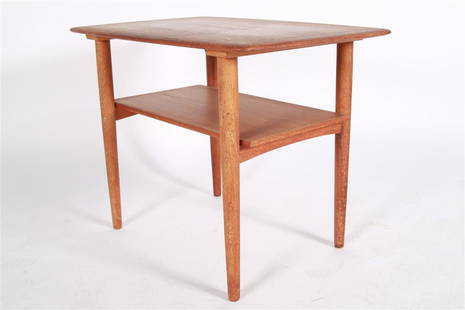 Povl Dinesen Teak Tiered End Table: Teak. Distributed by Povl Dinesen Cabinetmaker. Height: 22 1/4", Length: 29 1/4", Depth: 19 3/4". Teak tiered end table distributed by Povl Dinesen Cabinetmaker. Two Povl Dinesen silver labels to the