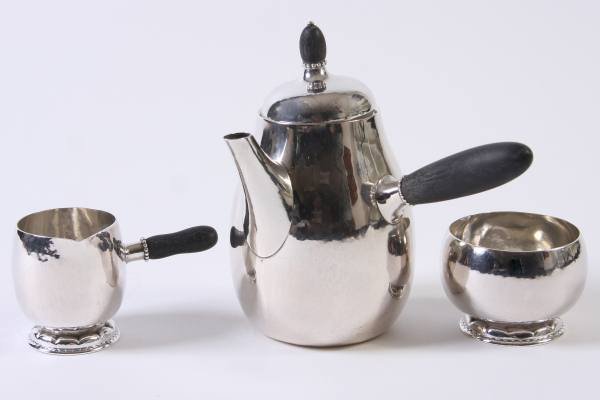 Georg Jensen Sterling Silver Coffee Set, 20 Ozt.: Georg Jensen sterling silver coffee service. Danish, 20th century. Including coffee pot, creamer, and open sugar. Coffee pot numbered "8". Creamer and sugar numbered "34". Coffee pot height 7 1/4". 20