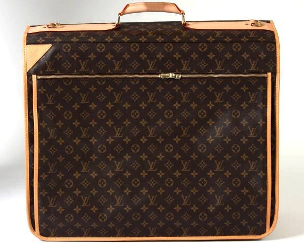 Louis Vuitton Garment Carrier: Louis Vuitton monogrammed canvas garment carrier with five large hangers, ID holder, hook, and padlock. With one outside pocket and two interior pockets with zipper closures. Includes removable adjust
