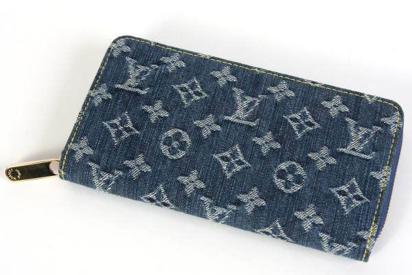 Louis Vuitton "Zippy" Wallet, Blue Denim: Louis Vuitton "Zippy" wallet made of blue denim monogrammed fabric. With gold hardware and leather interior. Single zipper closure. Interior with single zipper pocket, eight credit card slots, and six