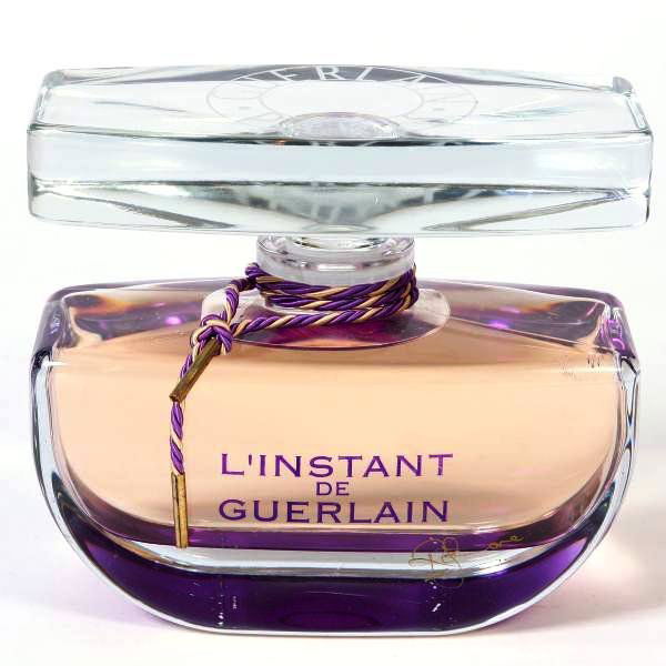Guerlain Factice "L'Instant" Parfum Bottle, Signed: Factice "L'Instant de Guerlain" perfume display bottle. made by Guerlain, Paris, France, 20th century. Signed on front of bottle. Height 8 1/4", width 9 1/2", depth 4 1/2".