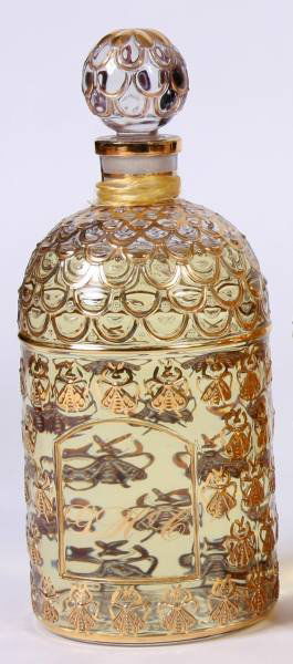 Guerlain Gilt "Champs-Elysees" 34 Oz. Perfume: An oversize bottle of Guerlain "Champs-Elysees" eau de toilette. Made by Guerlain, Paris, France, 20th century. The bottle having a bee pattern and decorated in gold gilt. 34 ounces. Height 10 1/4", d
